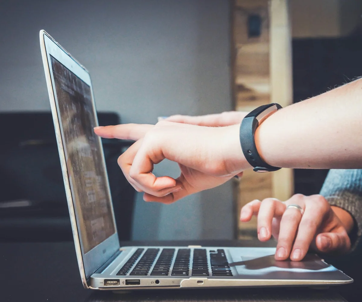 Two people exploring information together on a laptop.